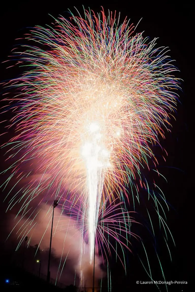 A series of fireworks are layered over each other as the fireworks display ends.