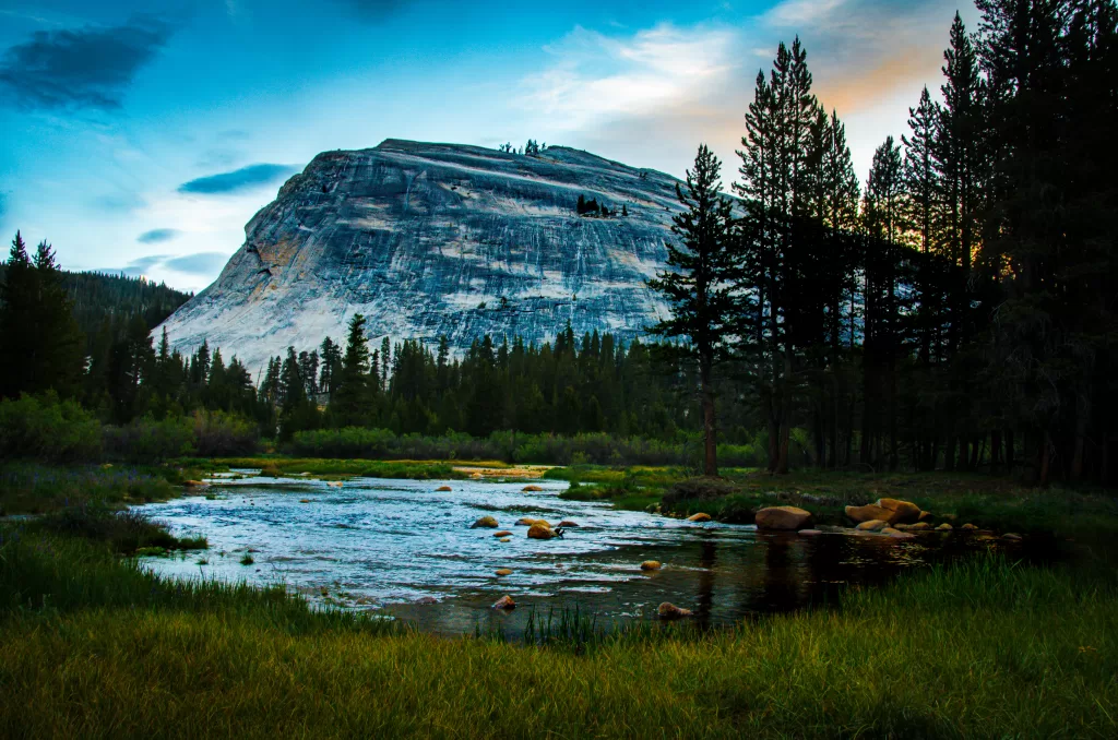 A photograph of a summer sunrise over the dome of Tuolumne Meadows in Yosemite National Park.