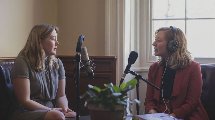 photography, two woman sitting in front of microphones, recording a podcast