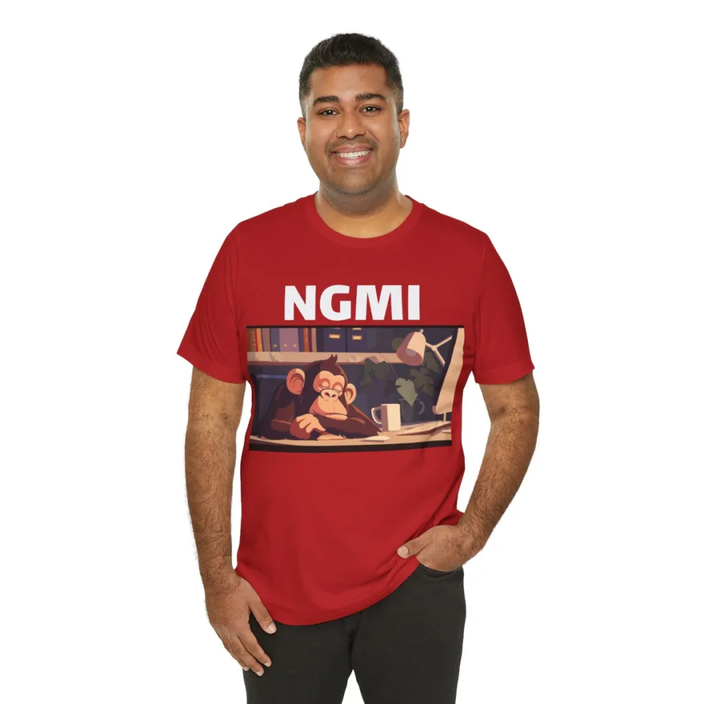 Man wearing a red shirt that says "NGMI" and features a sleepy ape.