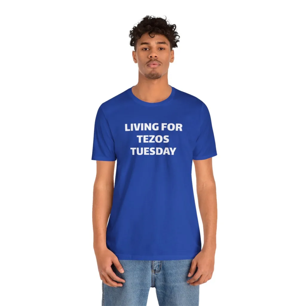 A man wearing a blue tshirt that says "Living for Tezos Tuesday"